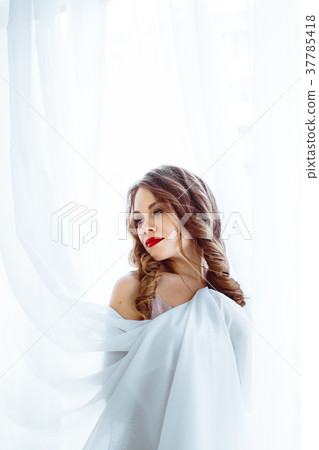 the woman standing at the window 37785418