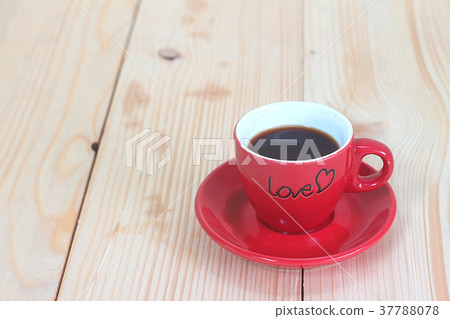 Red coffee cup on wood plate Red coffee cup on wood plate 37788078