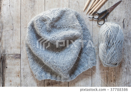 wool grey hat, knitting needles and yarn 37788386