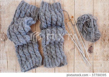wool grey legwarmers, knitting needles and yarn 37788395