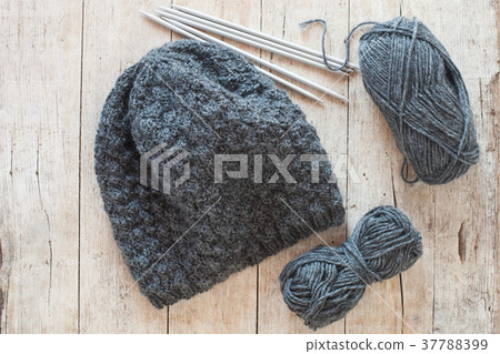 wool grey hat, knitting needles and yarn 37788399