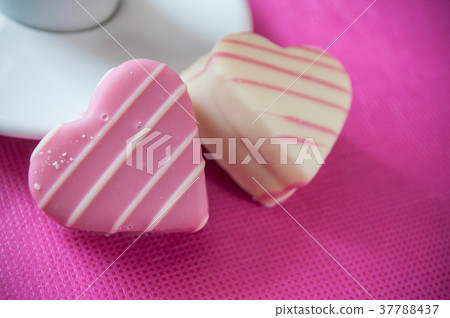 pink shaped heart pastry and cup of coffee  37788437