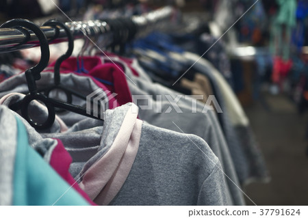 clothes hanging on a hanger in a store 37791624