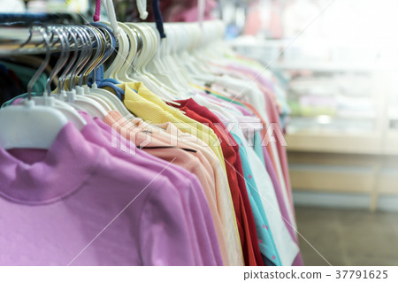 clothes hanging on a hanger in a store clothes hanging on a hanger in a store 37791625
