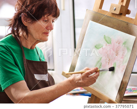 Artist painting easel in studio. Authentic Artist painting easel in studio. Authentic 37795071