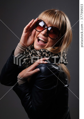 Young woman with sunglasses opening her mouth Young woman with sunglasses opening her mouth 37799603