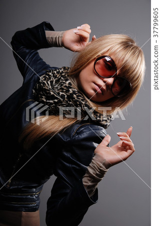 Young woman in sunglasses and scarf. Young woman in sunglasses and scarf. 37799605