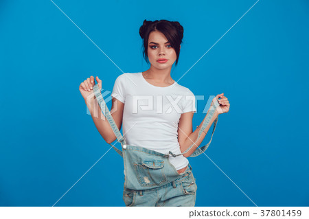 Attractive woman in a white t-shirt stands on a 37801459