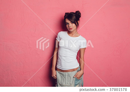 Attractive woman in a white t-shirt stands on a 37801578