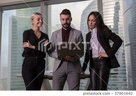 Business people work in a team for a laptop. Business people work in a team for a laptop. 37801692