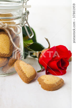 Heart-shaped cookies in a glass jar and red rose 37801959