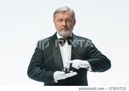 Senior waiter holding bell 37803728