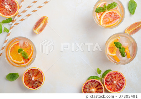 Cold refreshing drink with blood orange slices. 37805491