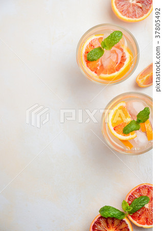 Cold refreshing drink with blood orange slices. 37805492