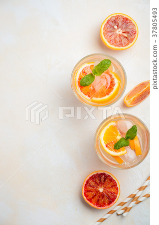 Cold refreshing drink with blood orange slices. 37805493