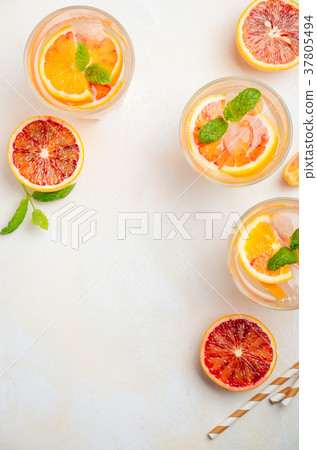 Cold refreshing drink with blood orange slices. 37805494