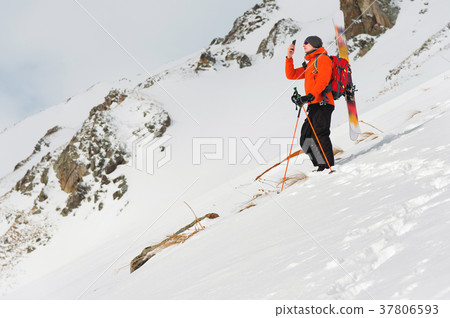 a ski freerider standing on a slope into a deep 37806593