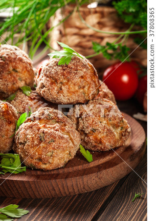 Stack of baked meatballs on a chopping board Stack of baked meatballs on a chopping board 37808365