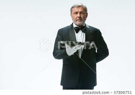 Senior waiter holding tray Senior waiter holding tray 37808751