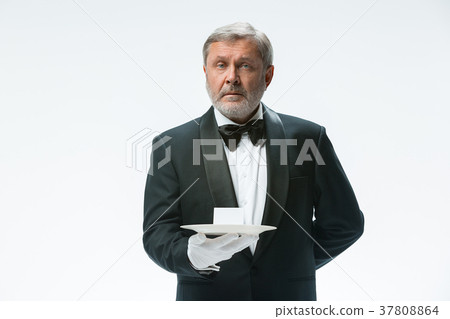 Senior waiter holding tray Senior waiter holding tray 37808864