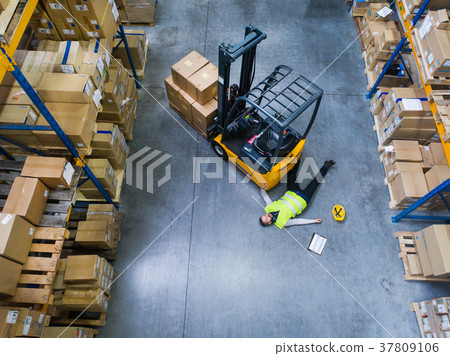 Warehouse worker after an accident in a warehouse. 37809106