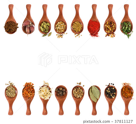 Different seasonings and spices in wooden spoons 37811127