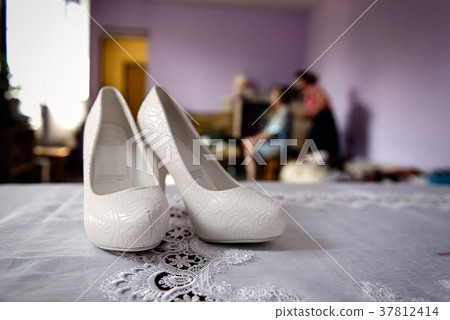 White wedding shoes in bride's room close White wedding shoes in bride's room close 37812414