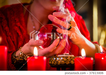 Soothsayer in Seance with Crystal ball and smoke 37813806