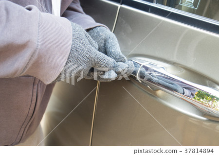 Thief trying to break into a car Thief trying to break into a car 37814894