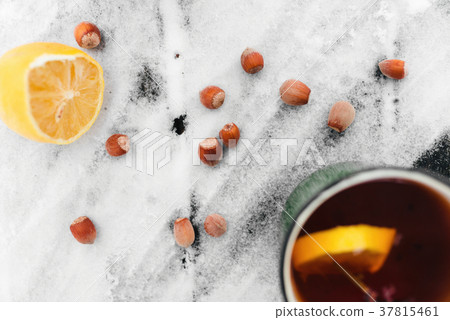 tea with lemon and cardamom on a snowy tea with lemon and cardamom on a snowy 37815461