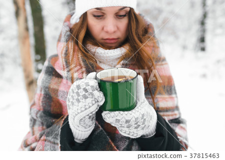 girl in a white hat wrapped in a rug holds girl in a white hat wrapped in a rug holds 37815463