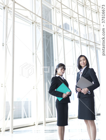 Business woman standing in lobby Business woman standing in lobby 37816673