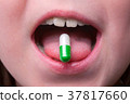 Close up of child puts the pill 37817660