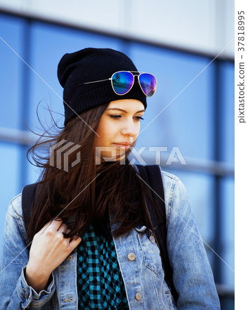 young pretty girl near business building walking young pretty girl near business building walking 37818995