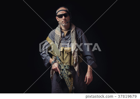 soldier of American special forces in Afghan clothes is holding a rifle soldier of American special forces in Afghan clothes is holding a rifle 37819679