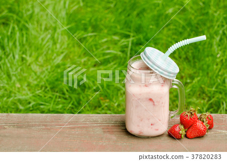 Mug of yogurt and strawberry 37820283