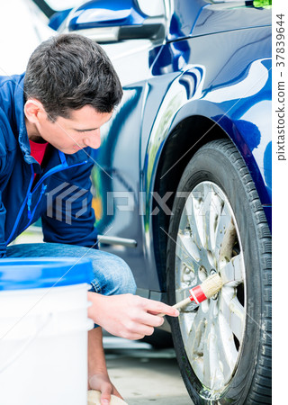 Man using brush for cleaning the surface of the Man using brush for cleaning the surface of the 37839644