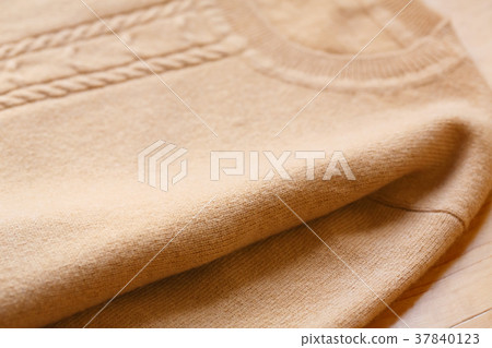 Winter clothing Beige knit sweater close up 37840123