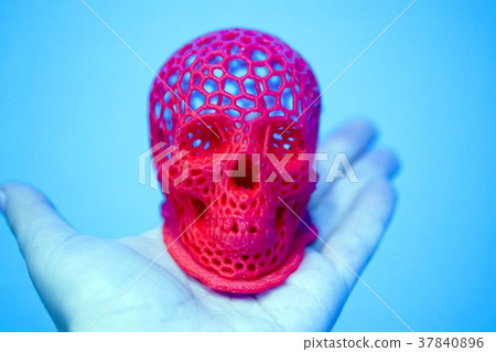 Skull printed with plastic of red color on a 3d 37840896