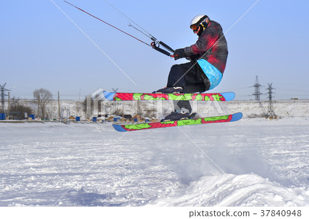 A male athlete engaged in snow kiting  37840948