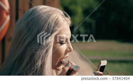 Close-up of a beautiful woman doing makeup 37841404