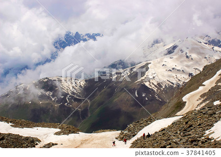 Clouds and snow clad mountains becoming one and 37841405
