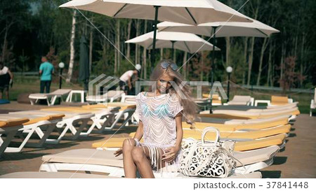 Beautiful woman lying on deck chair Young woman Beautiful woman lying on deck chair Young woman 37841448