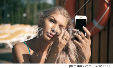 Close-up of a beautiful woman doing makeup 37841557