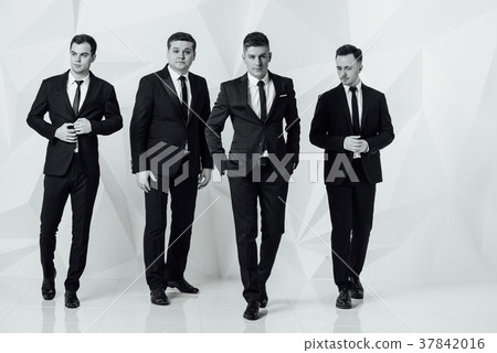Group of four men in suits white background 37842016