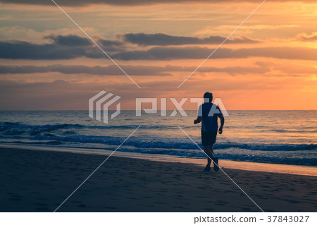Old man is running by the beach at sunrise. Old man is running by the beach at sunrise. 37843027