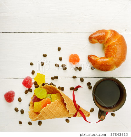 Cup of coffee, croissant, waffles and marmalade  Cup of coffee, croissant, waffles and marmalade  37843513