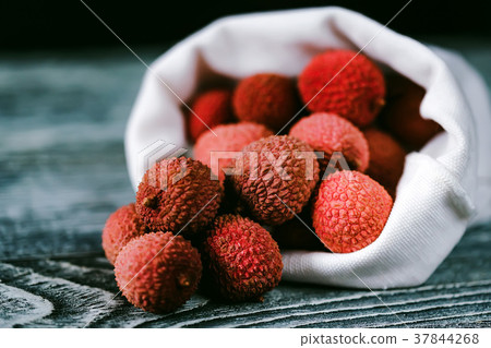 Lychee fruit in white sack close Lychee fruit in white sack close 37844268
