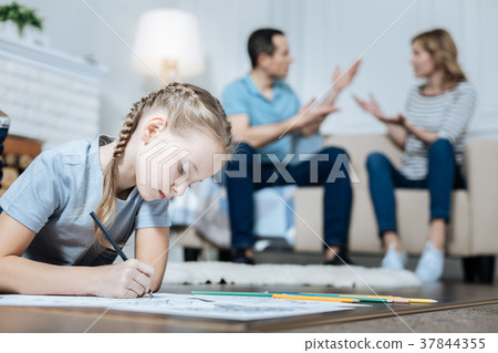 Unhappy little girl drawing on the floor 37844355