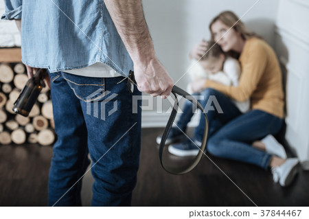 Violent and drunken daddy holding a bottle and 37844467